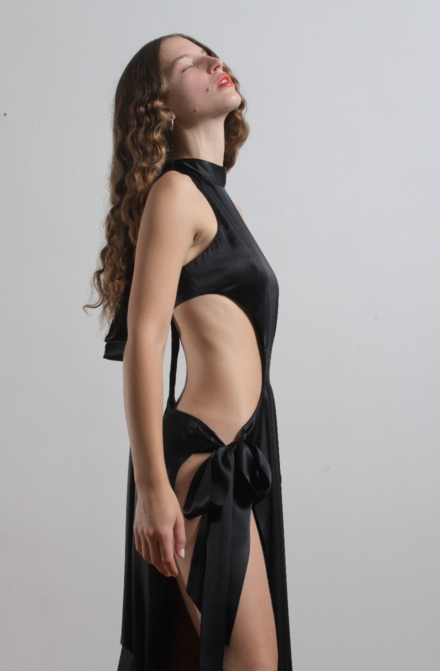 The Ava dress in black silk satin, with side ties and back zipper, side view of dress. 