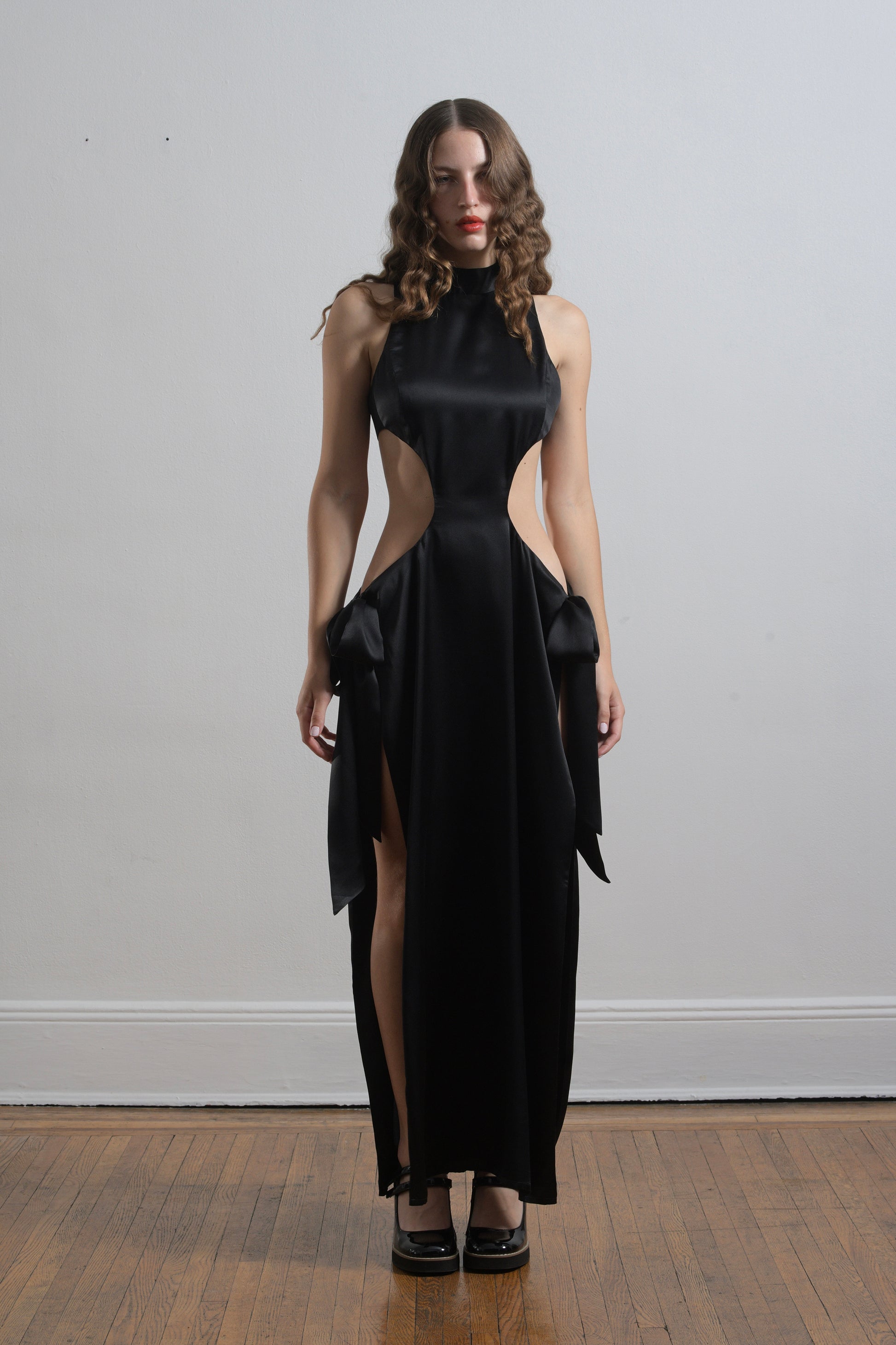 The Ava dress in black silk satin, with side ties and back zipper, front view of dress. 